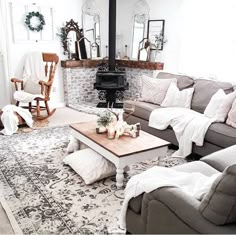 a living room filled with furniture and a fire place in the middle of the room