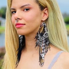 Model is wearing 8" You'll love these boho chic fringe earrings made with metallic silver and gold snake print genuine leather. The leather is lightweight and easy to wear with a black backside. They are fun and stylish, yet sophisticated and boho chic. High quality leather with brown backside. ✨Silver plated nickel free ear wire.✨ Choose your size: 4-8" Purchase for yourself or gift these leather fringe earrings. FAST SHIPPING  **Ships 1-2 business days.** All of my jewelry is 100% guaranteed a Trendy Festival Jewelry With Fringe, Summer Party Fringe Earrings, Trendy Black Earrings For Festivals, Trendy Black Festival Earrings, Black Fringe Jewelry For Festival, Trendy Black Fringe Jewelry, Edgy Black Earrings For Festival, Leather Fringe Earrings, Gold Snake