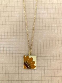 "Pretty and uplifting square sunflower necklace. Gold tone and painted enamel in shades of goldenrod, browns and cream. Pendant measures 3/4\" square and is on an 18\" chain. ★ Want to see more? Please visit my shop at: https://www.etsy.com/shop/DesignsByPeg" Royal Blue Jewelry, Music Necklace, Lily Necklace, Sunflower Gifts, Sunflower Pendant, Square Necklace, Sunflower Necklace, Music Jewelry, Blue Pendant