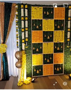 the backdrop is made up of yellow and green squares, with gold balls on each side