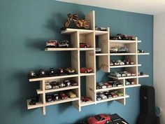 there are many toy cars on the shelves in this room