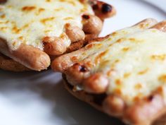 two pieces of pizza sitting on top of a white plate