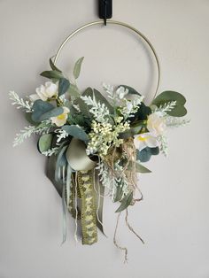 a wreath with flowers hanging on the wall