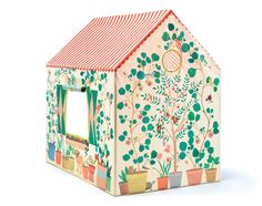 a toy house with trees and plants painted on it