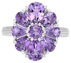 Indulge in the opulent radiance of this glamorous gemstone ring featuring a memorable floral arrangement that's sure to prompt admiration. From Ariva. Purple Stuff, Amethyst Stone, Floral Arrangement, Gemstone Ring, Pear Shaped, Prong Setting, Floral Arrangements, Gemstone Rings, Jewelry Rings