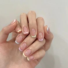 a woman's hands with french manies and nail polish