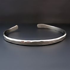 "Women's Thin Nickel Silver Stacking Bracelet. Wear this cuff alone or stack it with your favorite beaded bracelet, leather cuff or watch. This custom bracelet is the perfect gift. This cuff is made from 6 gauge nickel silver. It is custom sized for your wrist and has a 1-1.5 inch opening for sliding off and on. It is slightly adjustable. THIS LISTING IS FOR ONE CUFF BRACELET. CLICK HERE FOR THIS CUFF IN STERLING SILVER: https://www.etsy.com/listing/631858862/womens-thin-sterling-silver-stacking Jewelry Layering Bracelets, Hammered Cuff Bracelet, Hammered Bracelet, Mens Bracelet Silver, Father's Day Gifts, Hammered Sterling Silver, Sterling Silver Cuff Bracelet, Layered Bracelets, Nickel Silver