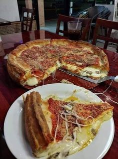 two slices of pizza sitting on top of a white plate next to eachother