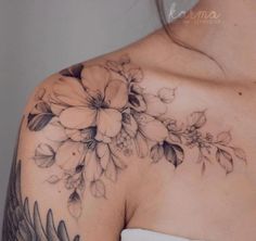 a woman's shoulder with flowers on it