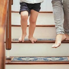 two children standing at the top of stairs