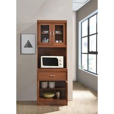 a microwave oven sitting on top of a wooden shelf next to an open cabinet filled with dishes