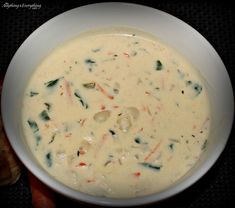 a white bowl filled with soup on top of a table