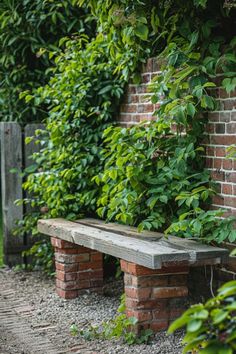 a wooden bench sitting next to a brick wall covered in green plants and ivys