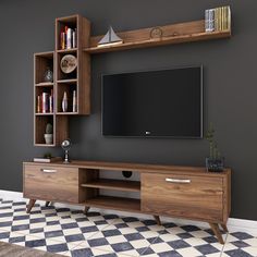 a living room with a large tv on the wall and checkered flooring in front of it