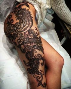 a woman's leg with tattoos on it and her legs covered in white fabric