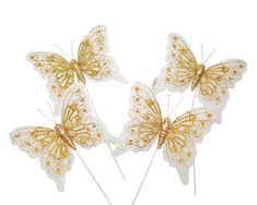 three white and gold butterflies on top of each other with yellow crystals in the wings