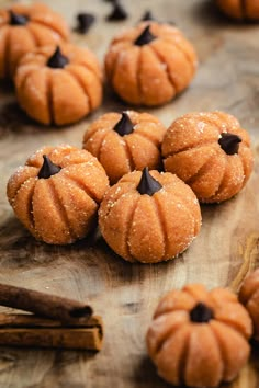 small pumpkins with chocolate chips on a wooden board next to cinnamon sticks and anisette