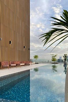 an empty swimming pool in front of a tall building