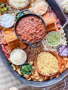 a platter filled with lots of different foods and dips on top of it