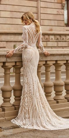 a woman in a wedding dress leaning on a railing