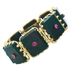 Circa 1860s, 18k, French. This fine 19th-century French bracelet, with its understated goldwork and ruby-set bloodstone, makes a spectacular au courant statement. Elegantly Napoleon the 3rd, the look is Town and Country chic French style! Glamorous, authentic vintage, it is as in today as it was fashionable 150 years ago. Meticulously fabricated in eighteen-karat gold, the bloodstone is finely figured and the ruby a gorgeous color. Excellent condition. Noted: Provenance, Receipt and appraisal from James Robinson, New York, dated 1977. Remark: "French fashion is a style all its own. French jewelry is simply timeless." SIZE: 7 1/8 inch long by 1 inch wide WEIGHT: 56.9 grams STONES: Bloodstone and finely hued ruby cabochons HALLMARKS: Eagle head, French assay mark for 18k, and French goldsmit French Bracelet, Chic French Style, Ruby Set, Slim Aarons, Gold Link Bracelet, French Jewelry, Antique Bracelets, Velvet Shoes, Jeweled Earrings