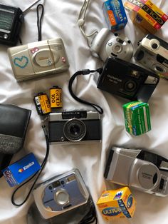 many different types of cameras on a bed