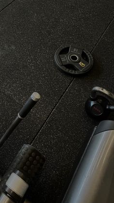 there is a pair of headphones on the floor next to an exercise bike wheel