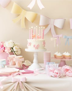 a table topped with lots of cake and cupcakes