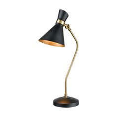 a black and gold desk lamp on a white background, with the light turned on