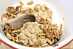 a bowl filled with oatmeal next to a wooden spoon