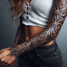 a woman with tattoos on her arm and shoulder