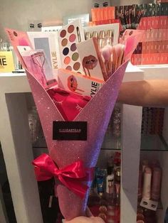 there is a pink vase with makeup on it