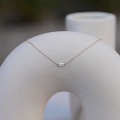 The Sam Necklace is the perfect dainty necklace for sophistication and fun. It's intentionally petite so you never have to take it off, while also being the perfect staple necklace you can layer with chains, crosses, or other diamond styles. It features a .25 carat oval diamond, measuring about 5mm x 3.5mm. It sits in a custom-designed invisible setting, and is fixed horizontally on a dainty 16-18" adjustable chain. Use code "SAMCIACCIA" at checkout for free shipping, and for an automatic contri Minimalist Solitaire Necklace With Diamond Cut For Everyday Luxury, Minimalist Luxury Necklace With Diamond Accents, Minimalist Single Diamond Jewelry For Everyday Luxury, Minimalist Everyday Luxury Necklace With Diamond Accents, Minimalist Solitaire Diamond Necklace For Everyday Luxury, Everyday Fine Jewelry Solitaire Necklace With Single Diamond, Everyday Fine Jewelry Solitaire Necklace In Diamond White, Minimalist Single Cut Diamond Necklace For Everyday Luxury, Everyday Luxury Sterling Silver Necklace With Single Diamond