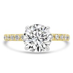 a yellow and white gold engagement ring with diamonds on the band, set in 18k gold