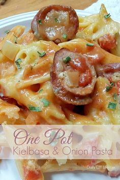 one pot kielbasa and onion pasta on a white plate with the title above it