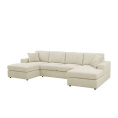 a white sectional couch sitting on top of a white floor