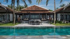 an outdoor dining area next to a swimming pool