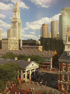 an aerial view of a city with tall buildings and people walking on the sidewalk in front of it