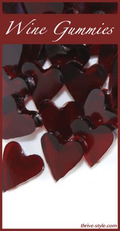 wine gummies in the shape of hearts on a white surface with red lettering that reads wine gummies