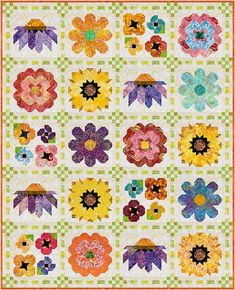 a colorful quilt with many different flowers on the front and back, all arranged in squares