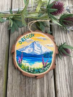 a wooden ornament with the name oregon painted on it