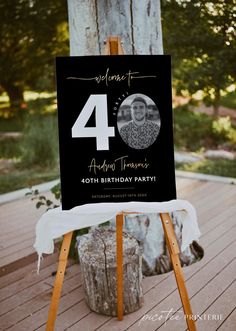 a black and white photo on a wooden easel with the number forty birthday party sign