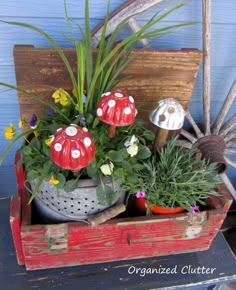 an old wooden wagon filled with potted plants and mushrooms on top of it's wheels