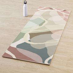 a yoga mat on the floor with a pen next to it