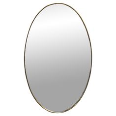 an oval mirror on a white background with a gold frame and metal trim around the edges