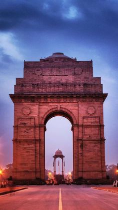 a large stone arch on the side of a road