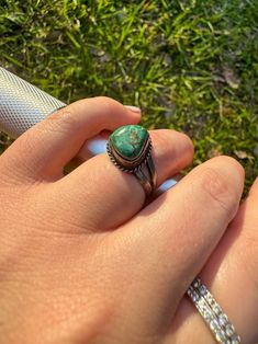 vintage Sterling silver ring and raw turquoise ring | small detailed rope around the stone | the stone is a light blue/green color with some light brown Carmel color | such a pretty stone! | size 7 | feel free to send us a message with any questions you may have! Green Turquoise Bohemian Promise Ring, Green Bohemian Turquoise Promise Ring, Vintage Turquoise Promise Ring, Turquoise Vintage Promise Ring, Vintage Adjustable Green Turquoise Ring, Green Turquoise Cabochon Ring, Raw Turquoise Ring, Sterling Silver Round Turquoise Multi-stone Ring, Carmel Color