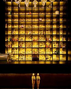 two gold figurines in front of a lighted display case