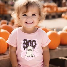 The perfect Halloween vibe shirt that will embrace your love of Halloween and the Fall season. This super soft shirt is made from a soft, midweight 100% fabric for easy layering when it gets chilly or throw it on alone for comfort.  It makes a great gift for your kids for fall parties and Halloween get togethers! All items are made to order.  They will ship within one week from one of our printing partners.  Please allow sufficient time for production and shipping.  Luxurious comfort and style a Playful Pre-shrunk Tops For Halloween, Playful Fall T-shirt With Cartoon Print, Cute Fitted Shirt For Fall, Playful Halloween T-shirt With Cartoon Print, Fun Halloween Short Sleeve Shirt, Cute Cotton Halloween Shirt, Playful Crew Neck Tops For Halloween, Cute Halloween Tops With Character Print, Cute Halloween Short Sleeve Tops