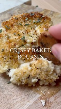 a close up of a piece of food on a cutting board with the words crispy baked bourssin